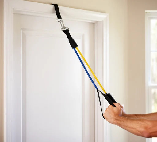 Resistance band set in use during a row exercise with a door anchor