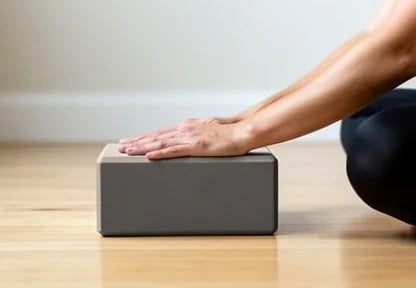 Yoga block used as a hand support during a forward fold