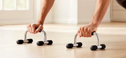 Push-up bars in use during a floor workout